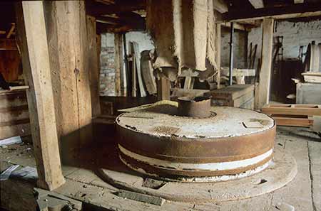 A set of millstones in situ within the mill prior to the 2006 fire