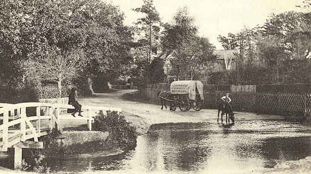 Brockenhurst - an idyllic scene as a pony takes a drink at the water splash, a nearby horse-drawn wagon delivers beer - it is marked 'Strong and Co of Romsey, Brewers' - whilst a child watches on from a vantage point atop the bridge railings