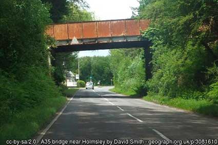 The route of Castleman's Corkscrew here at Holmsley is now in use for a minor road passing beneath the A35, which is carried on the rusting iron bridge show in the picture