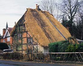 Re-thatching underway at the old turnpike cottage